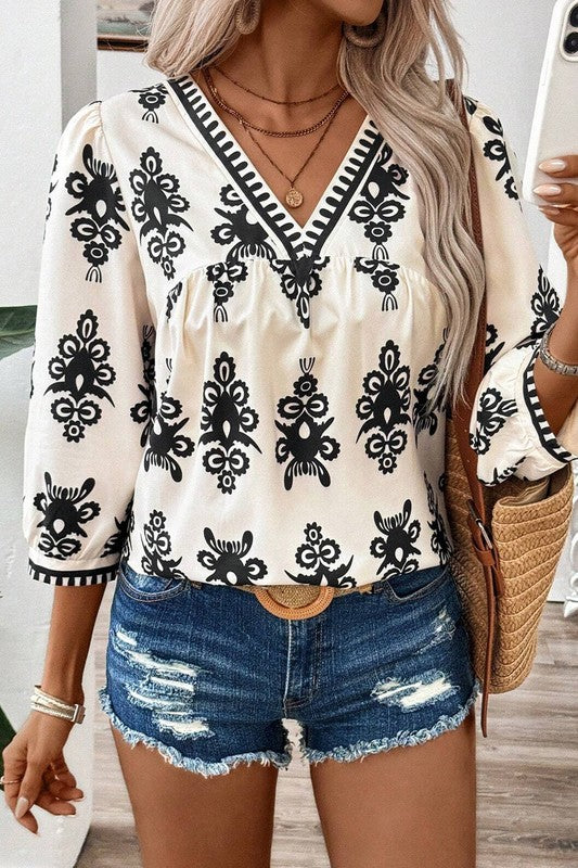 Joy - Elegante blusa con estampado geométrico de media manga y cuello en V