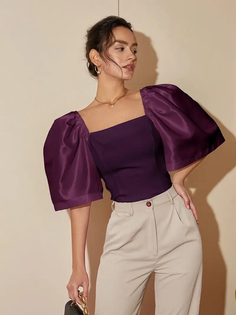 Clara – Elegante blusa de raso con mangas abullonadas