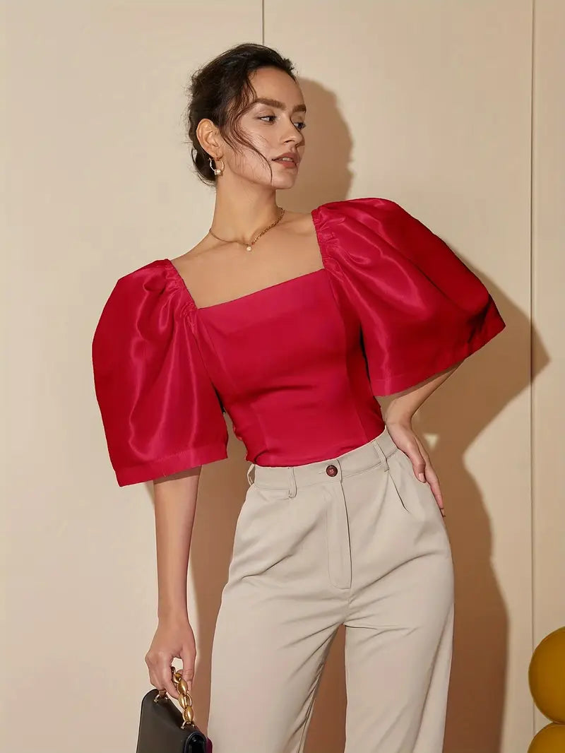 Clara – Elegante blusa de raso con mangas abullonadas